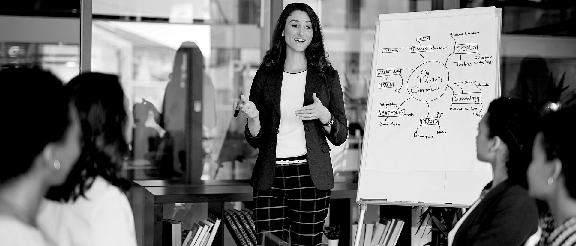 Leadership Sessions- Black and white image of women giving a presentation